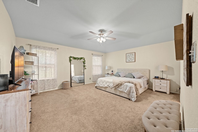 bedroom with ceiling fan and light colored carpet