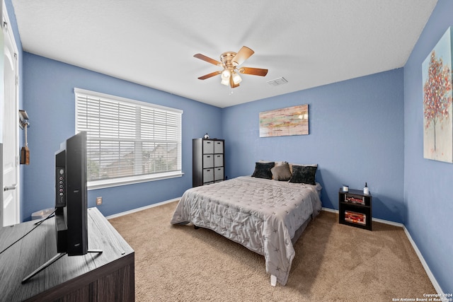 bedroom featuring ceiling fan and light carpet