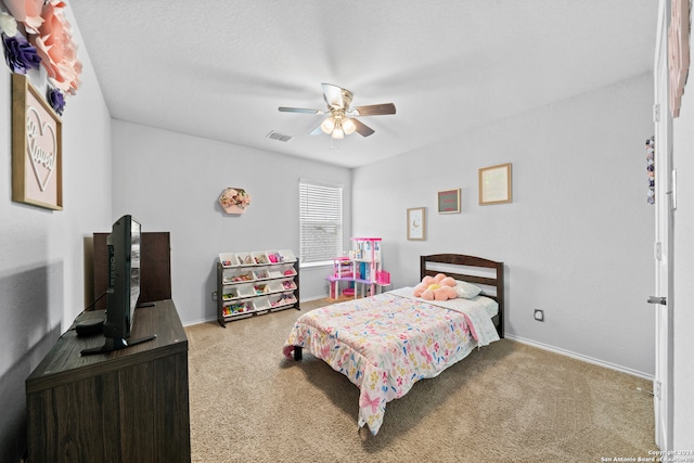 carpeted bedroom featuring a textured ceiling and ceiling fan