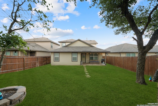 rear view of house with a yard