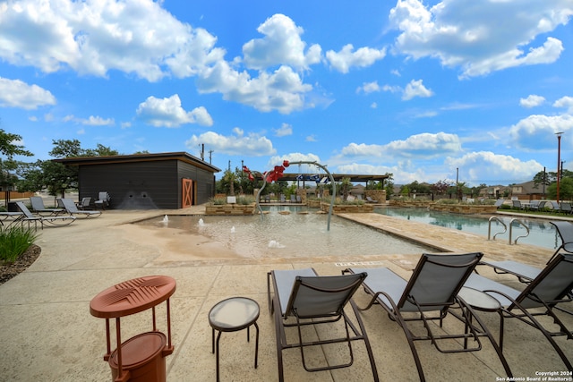 view of swimming pool with a patio area