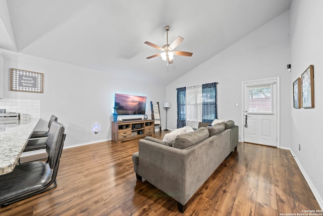 living room with ceiling fan, dark hardwood / wood-style floors, and high vaulted ceiling