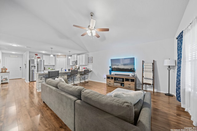 living room with vaulted ceiling, dark hardwood / wood-style floors, and ceiling fan