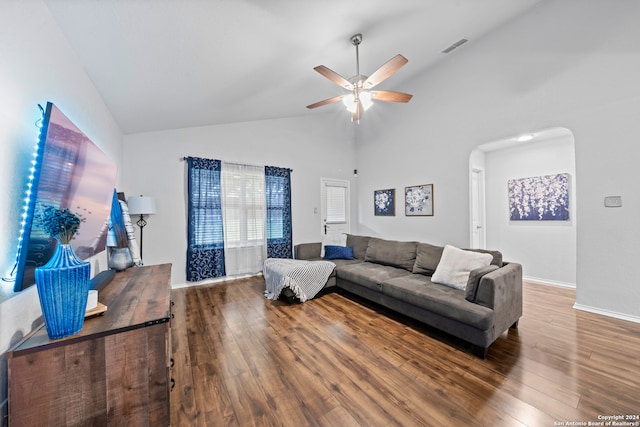 living room with ceiling fan, dark hardwood / wood-style floors, and vaulted ceiling