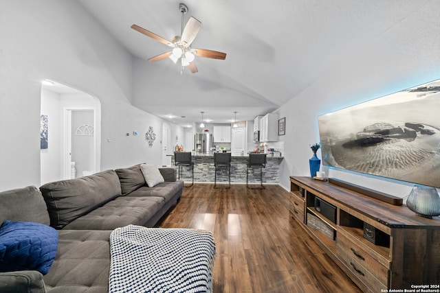 living room with dark hardwood / wood-style flooring, high vaulted ceiling, and ceiling fan