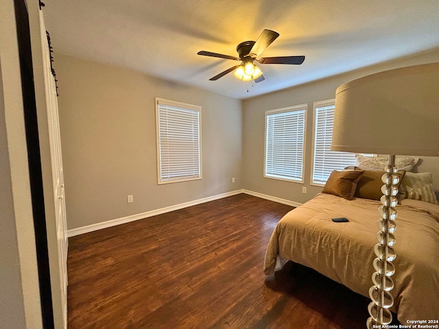 bedroom with dark wood-type flooring and ceiling fan