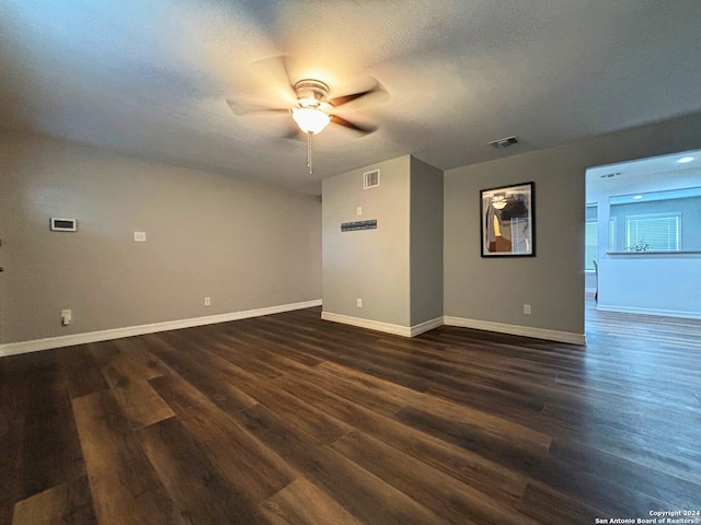 unfurnished room with dark wood-type flooring, a textured ceiling, and ceiling fan