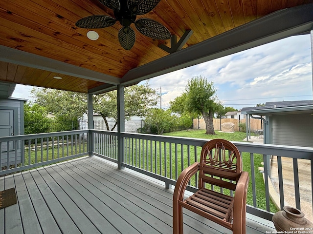 deck with a yard and ceiling fan