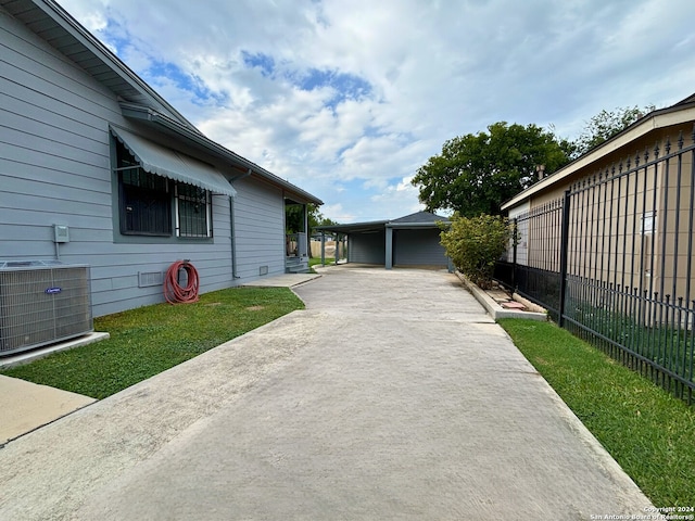 exterior space featuring a carport and central AC