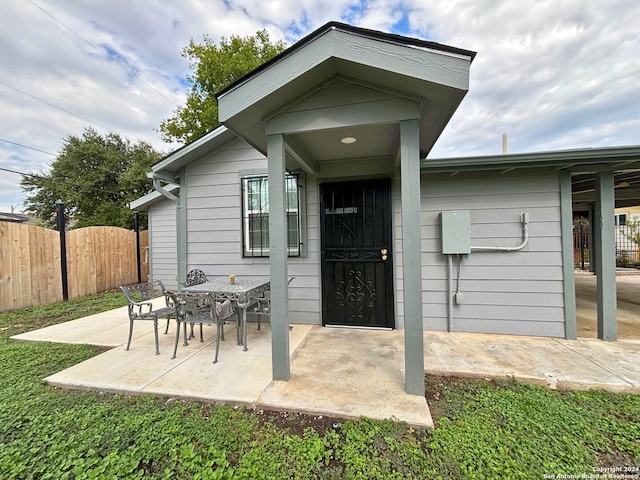 entrance to property featuring a patio