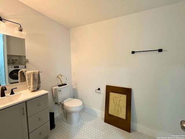 bathroom with washer / clothes dryer, vanity, and toilet