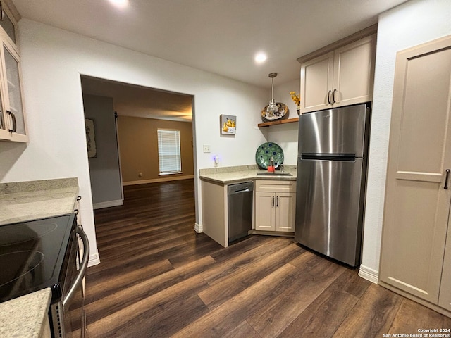 kitchen featuring appliances with stainless steel finishes, dark hardwood / wood-style floors, and hanging light fixtures