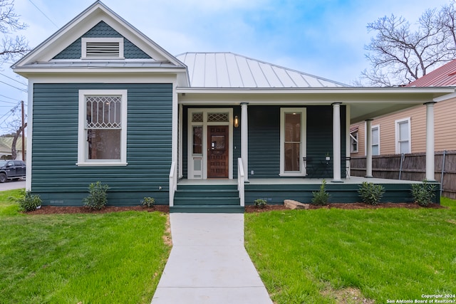 view of front of property with covered porch and a front yard