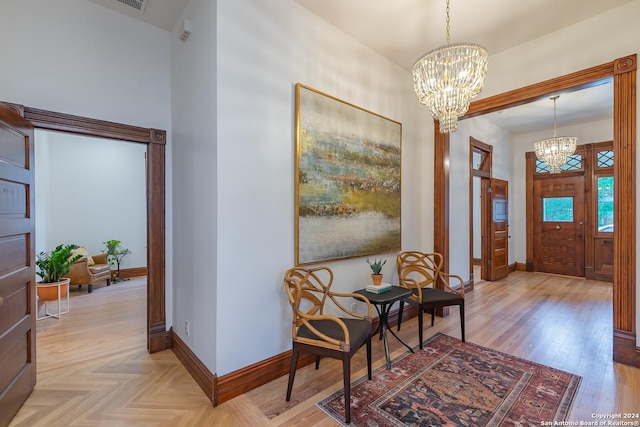 entrance foyer with baseboards, parquet floors, and an inviting chandelier