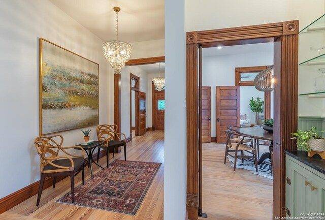 interior space featuring light wood-type flooring and a chandelier