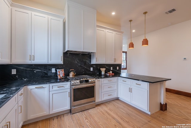 kitchen featuring decorative light fixtures, white cabinetry, kitchen peninsula, dark stone counters, and stainless steel range with gas cooktop