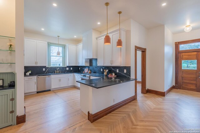 kitchen with decorative light fixtures, white cabinets, stainless steel appliances, and kitchen peninsula