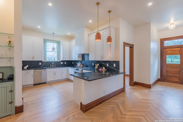 kitchen featuring dark countertops, stainless steel appliances, tasteful backsplash, and a peninsula