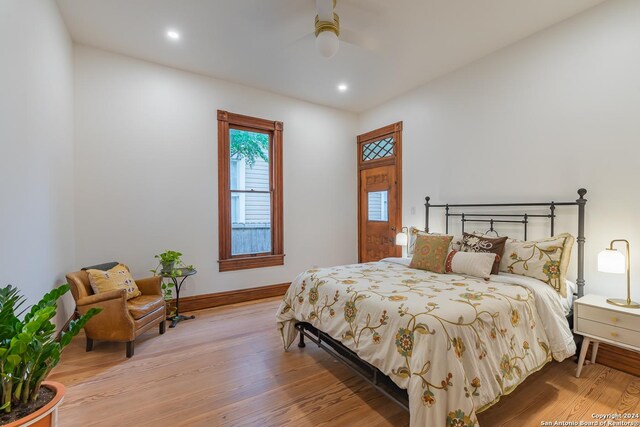 bedroom with light hardwood / wood-style flooring and ceiling fan