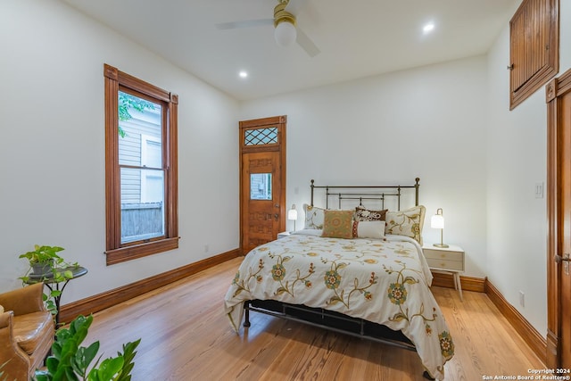 bedroom with baseboards, recessed lighting, and light wood-style floors