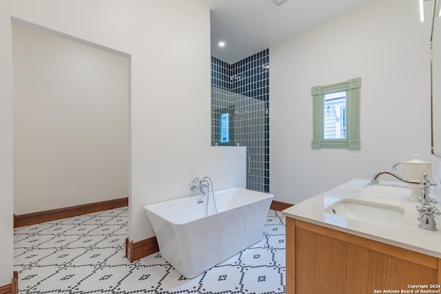 full bath featuring double vanity, baseboards, tiled shower, a soaking tub, and a sink