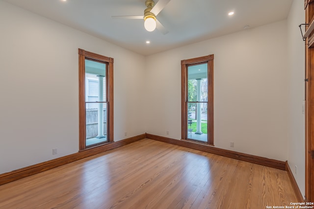 empty room featuring ceiling fan and light hardwood / wood-style flooring