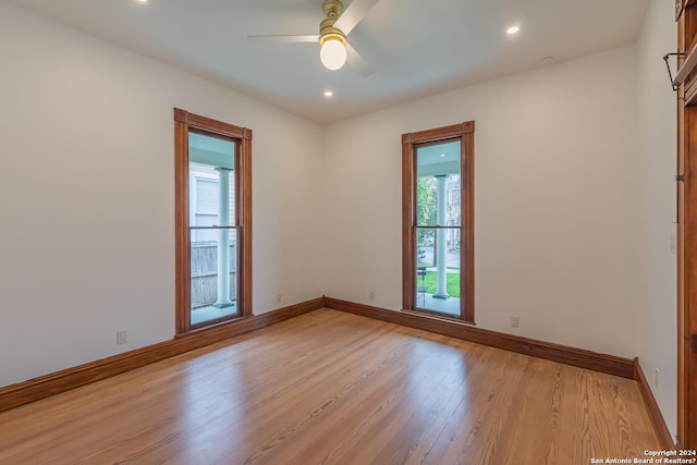 unfurnished room with a ceiling fan, recessed lighting, light wood-style flooring, and baseboards