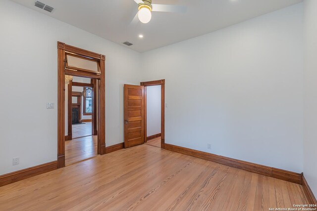 unfurnished room featuring light wood-type flooring and ceiling fan