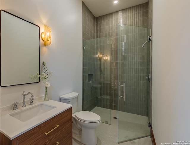 full bath featuring a stall shower, vanity, toilet, and tile patterned floors