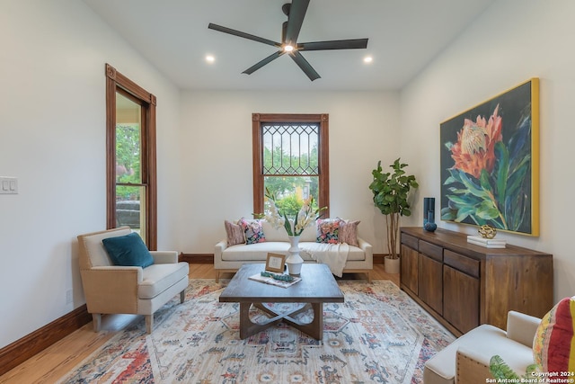 living room with baseboards, ceiling fan, recessed lighting, and light wood-style floors