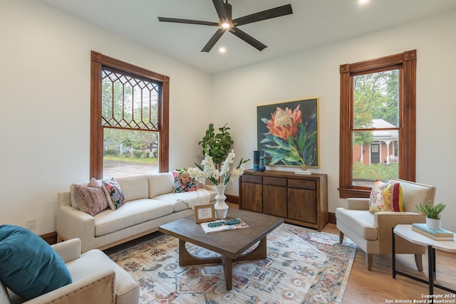 living room with light wood-style floors, recessed lighting, ceiling fan, and baseboards