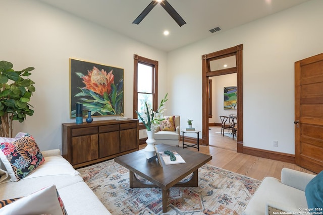 living room with recessed lighting, visible vents, light wood-style flooring, a ceiling fan, and baseboards