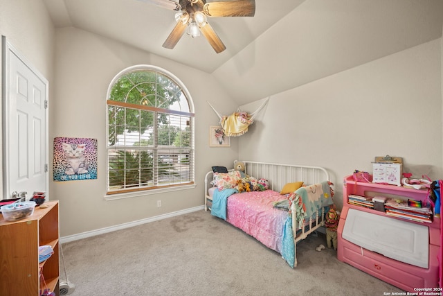 carpeted bedroom with ceiling fan and vaulted ceiling