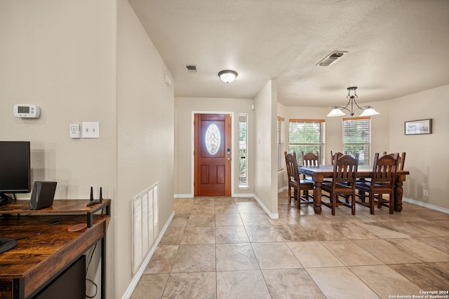 foyer entrance with a textured ceiling