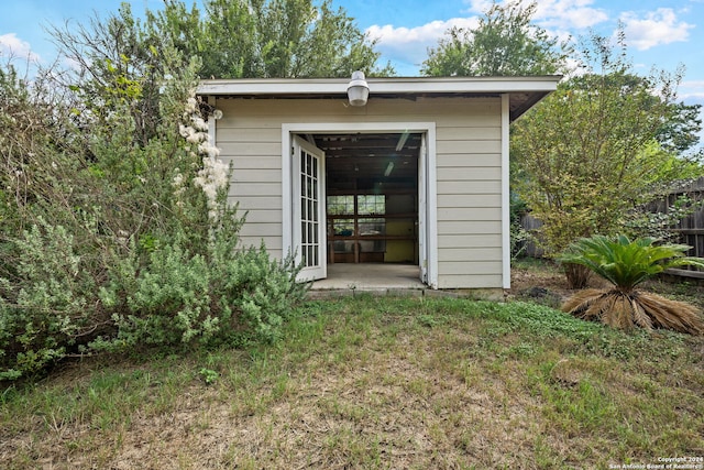 view of outdoor structure featuring a lawn