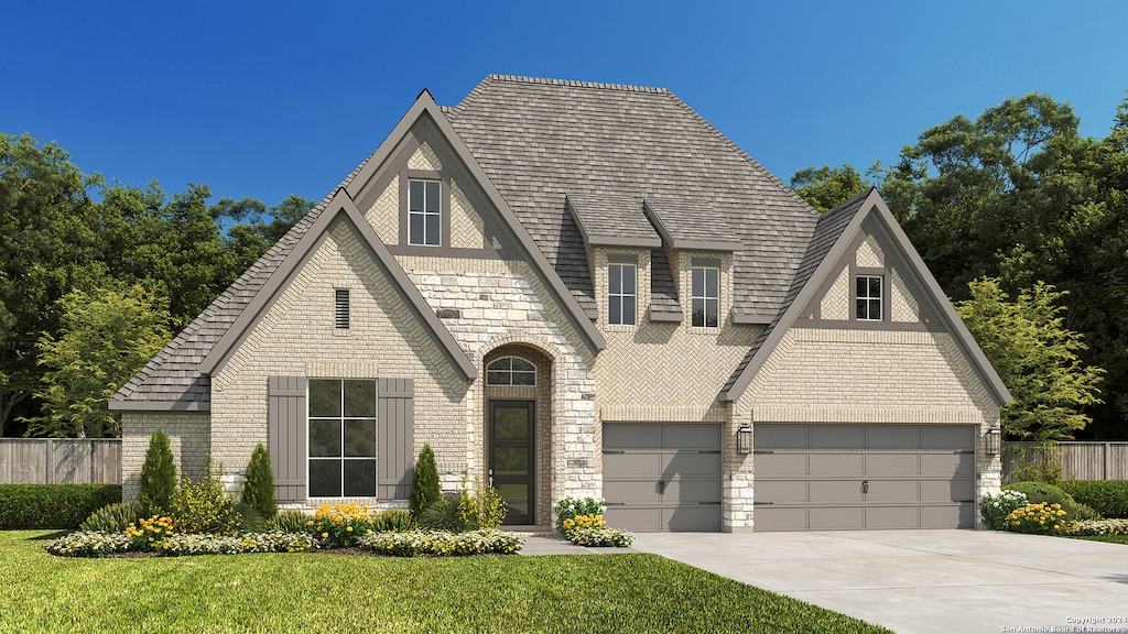 view of front of house with a front yard and a garage