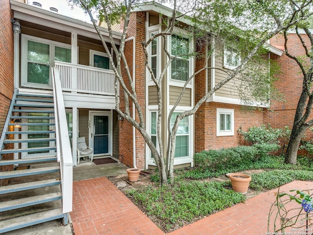 exterior space featuring a porch and brick siding