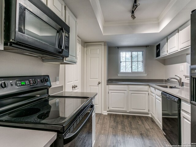 kitchen featuring black appliances, sink, a raised ceiling, and white cabinets