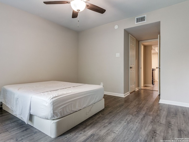 unfurnished bedroom featuring ceiling fan and dark hardwood / wood-style floors