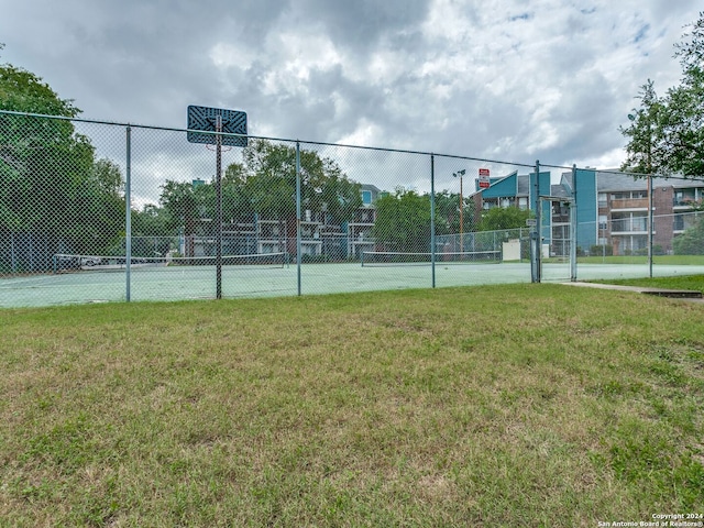 view of sport court featuring a yard