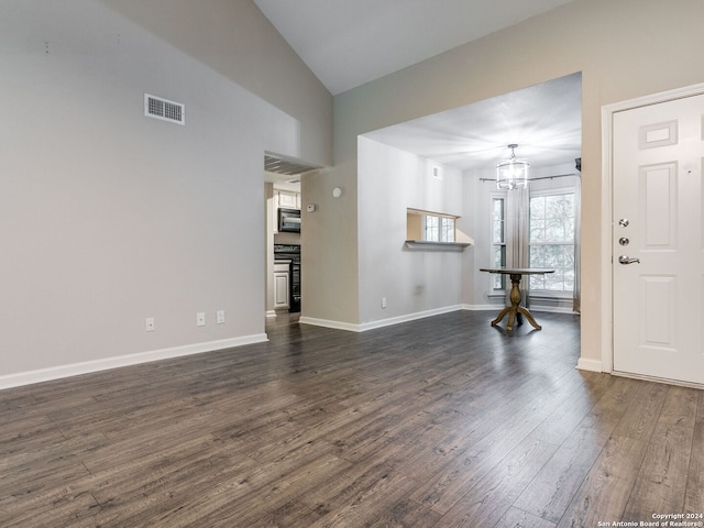 unfurnished living room featuring dark hardwood / wood-style flooring and vaulted ceiling