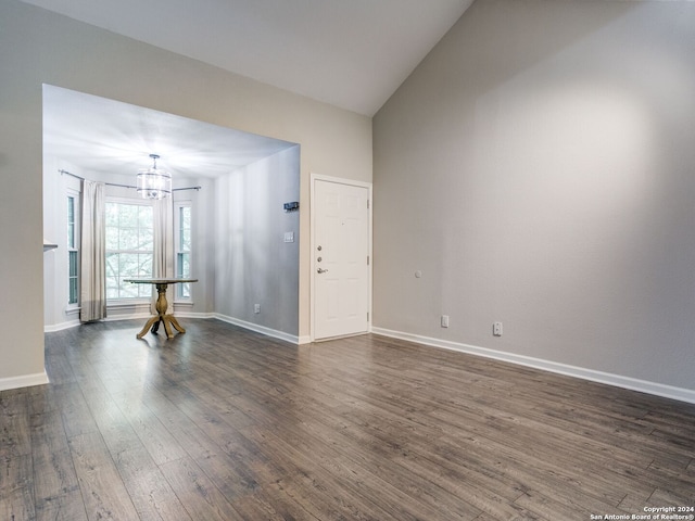 interior space featuring lofted ceiling, a chandelier, and dark hardwood / wood-style floors