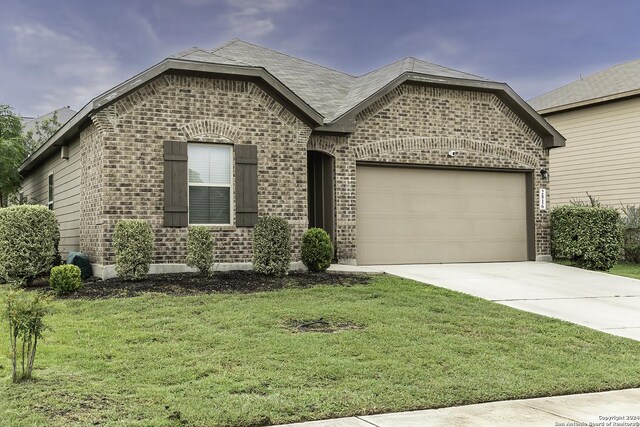 view of front of house featuring a garage and a front yard