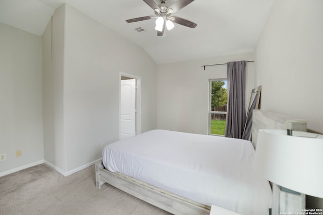 carpeted bedroom with ceiling fan and vaulted ceiling