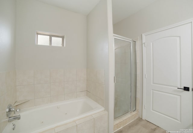 bathroom featuring separate shower and tub