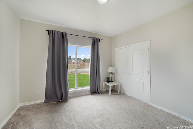 unfurnished room with light carpet