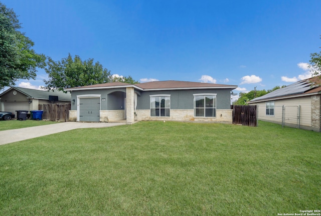 view of front of house featuring a front yard and a garage