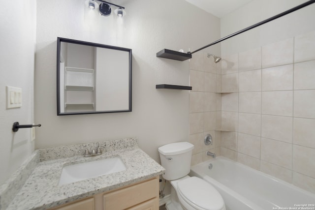 full bathroom with tiled shower / bath, toilet, and vanity