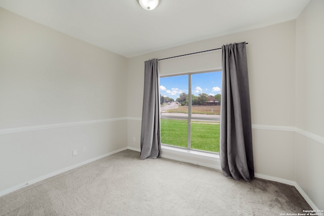 unfurnished room featuring light carpet