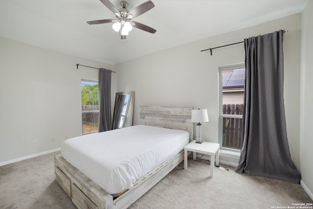 bedroom with light colored carpet and ceiling fan